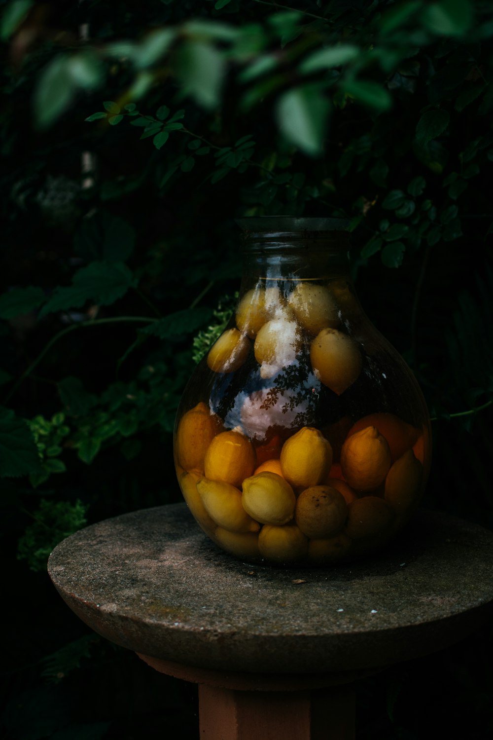 yellow fruits in clear glass jar