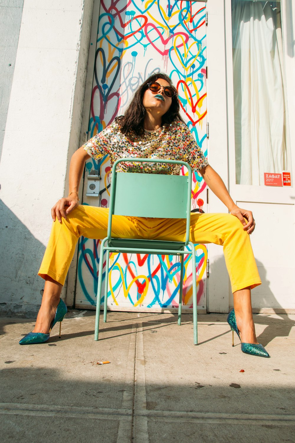 woman in yellow sleeveless dress sitting on yellow chair