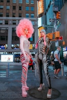 A group of diverse individuals wearing futuristic clothing in an urban environment.