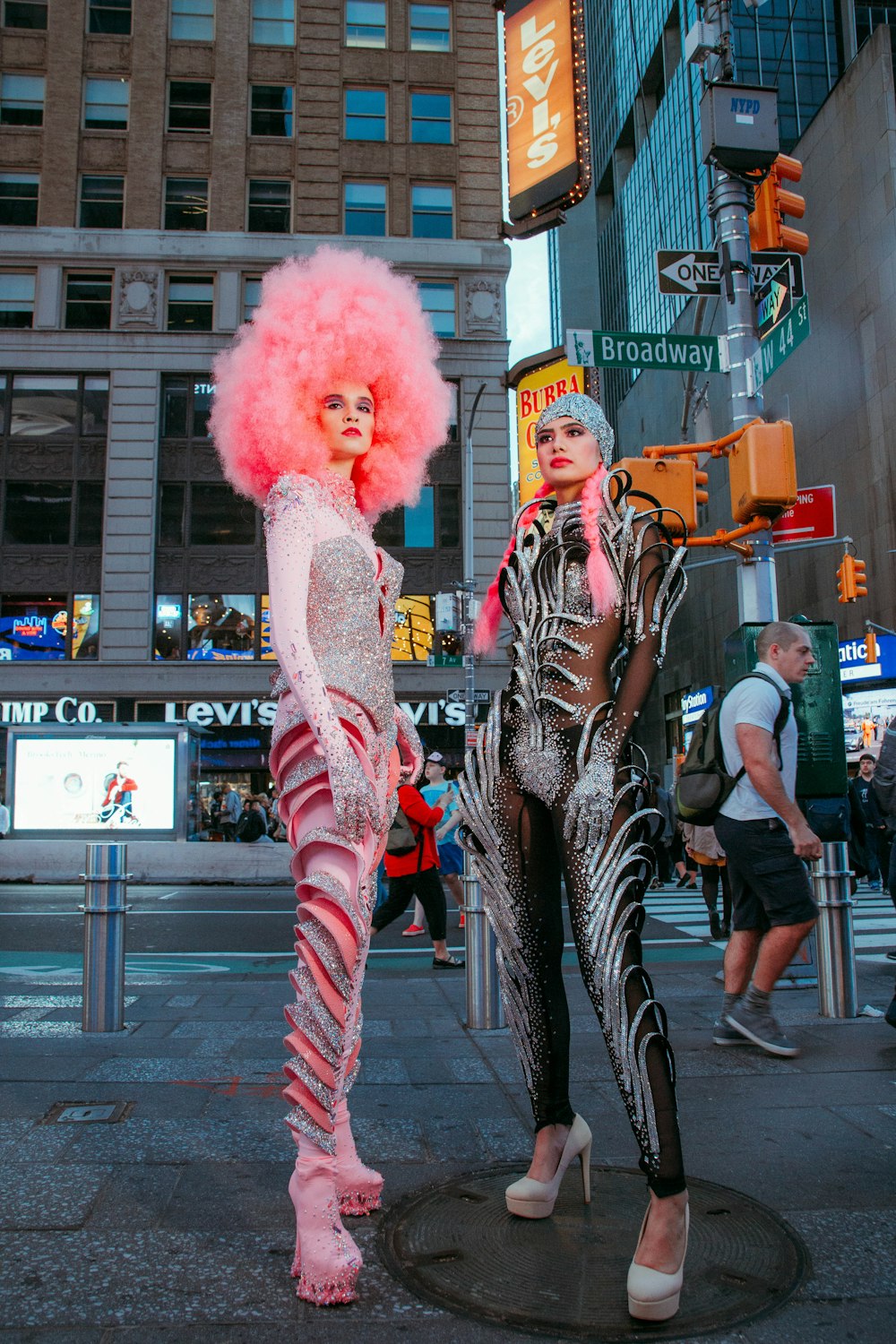 2 women standing beside pink and white animal statue