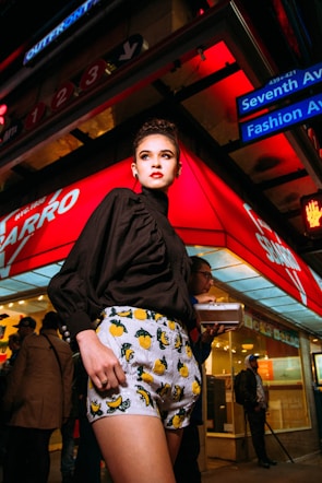 A vibrant street scene featuring a model wearing mxmentum’s trendy outfit, blending urban life and fashion.