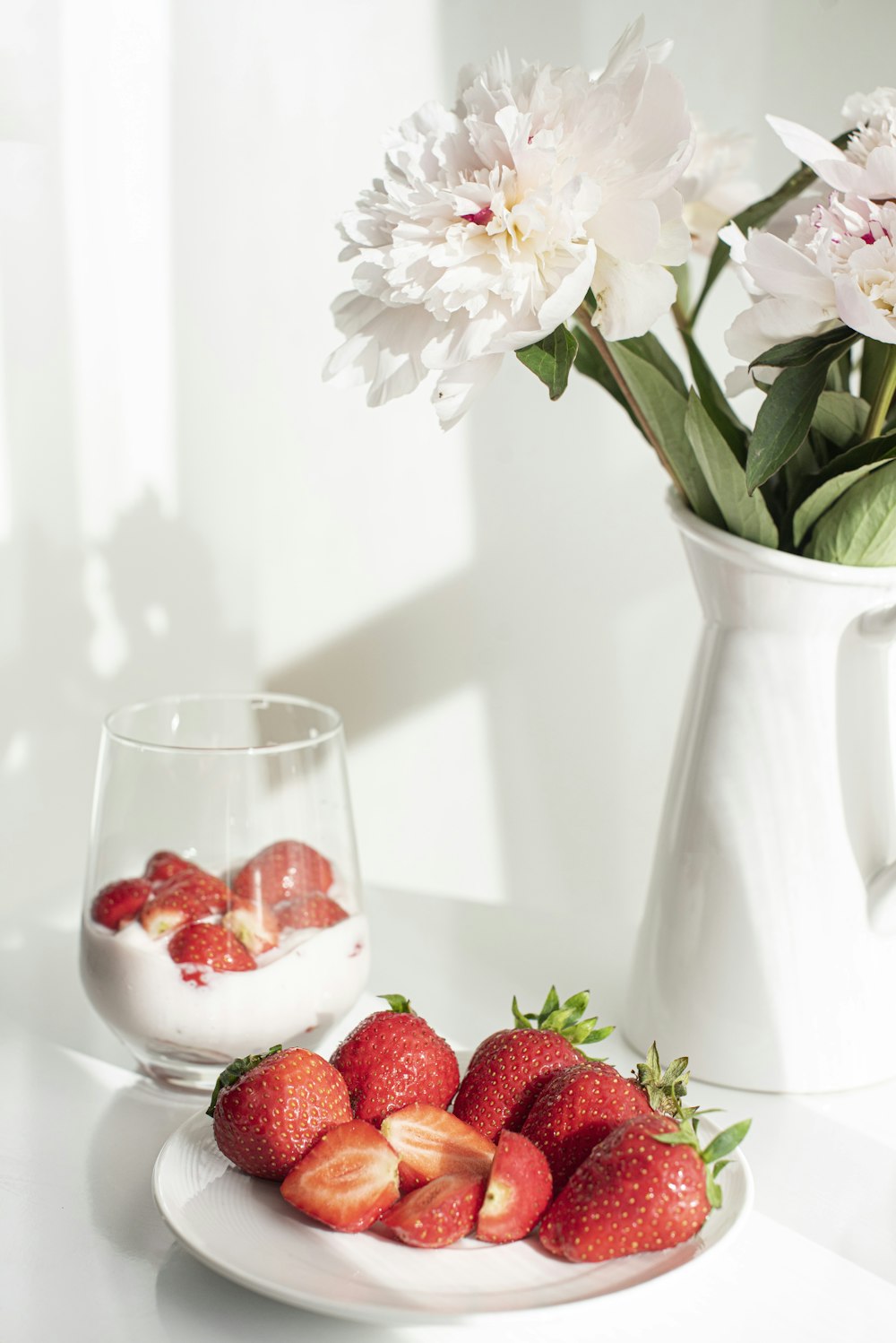 white flowers in white ceramic vase