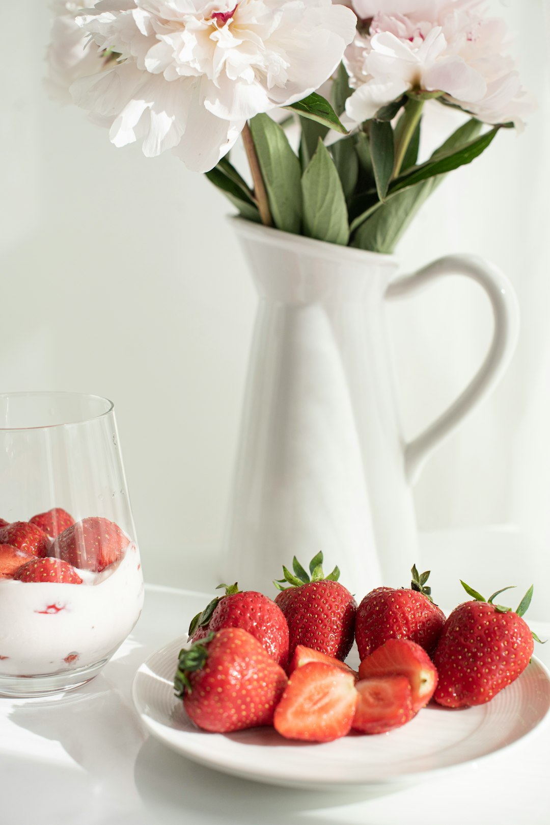 strawberries in white ceramic pitcher