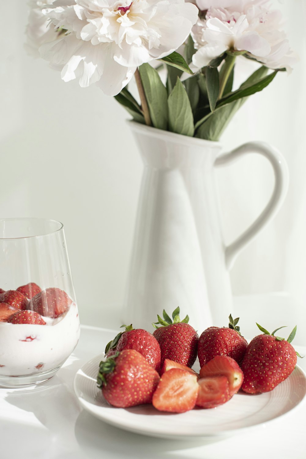 strawberries in white ceramic pitcher