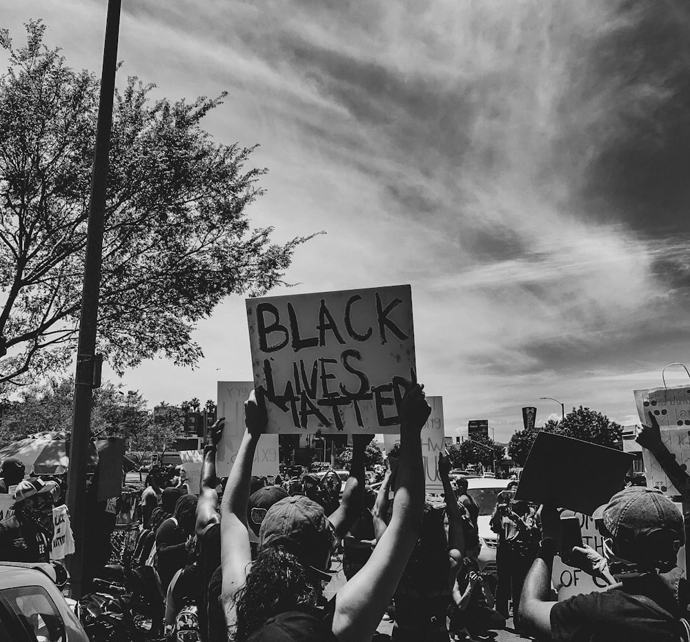 grayscale photo of people in street