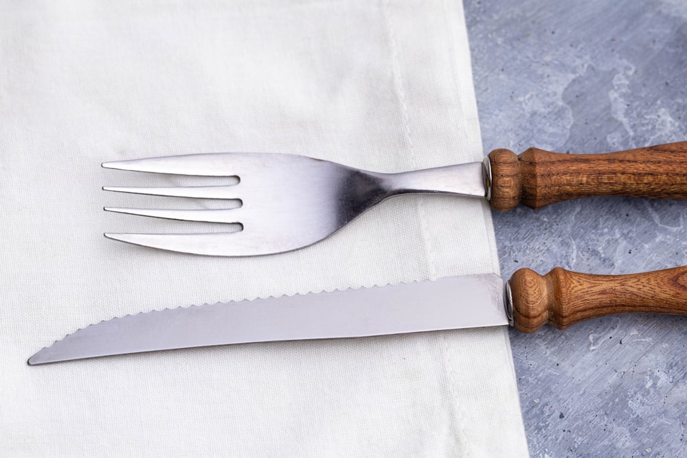 brown wooden handle fork on white textile