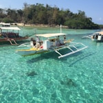 white and brown boat on body of water during daytime