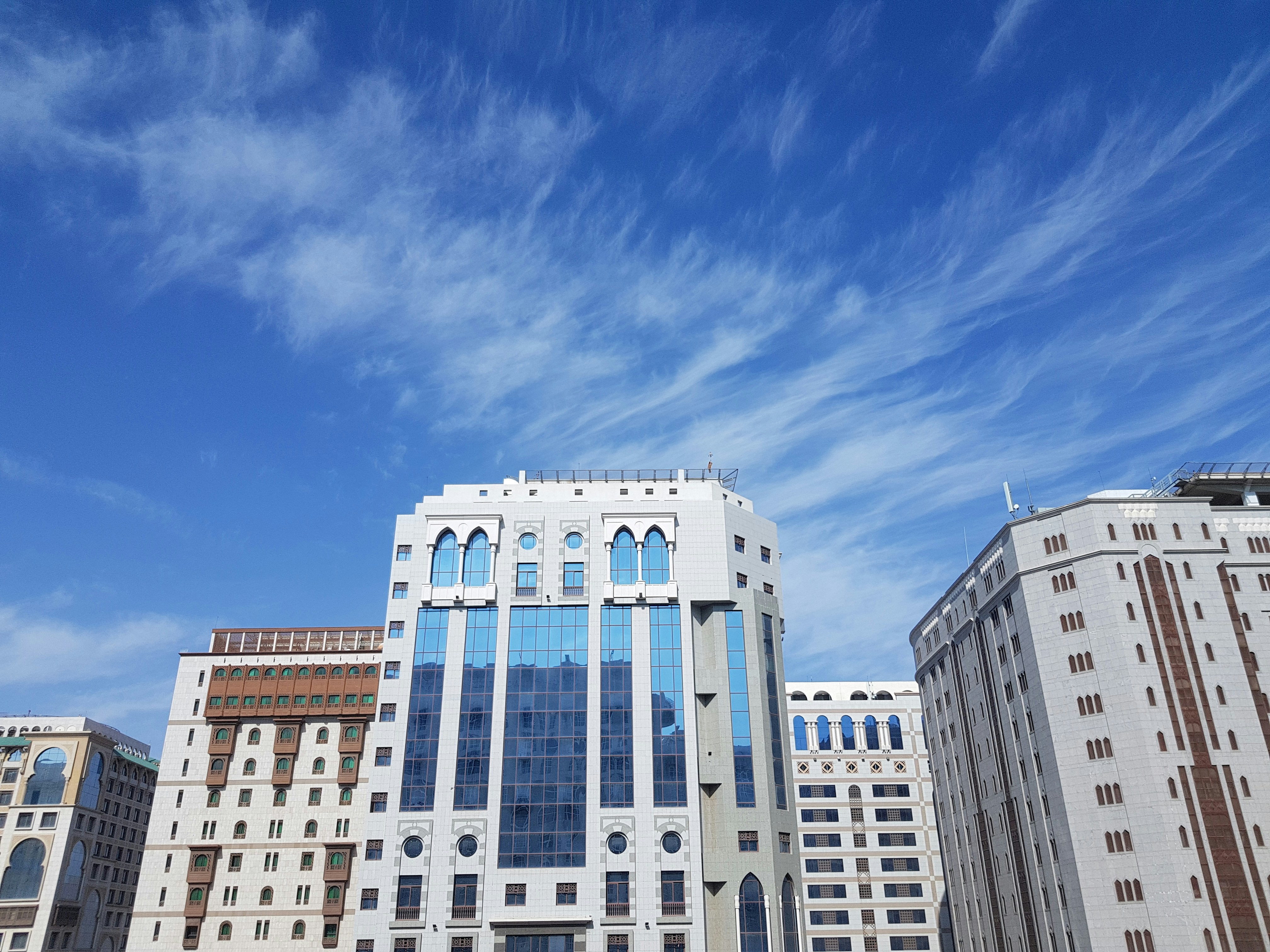 white and blue concrete building under blue sky during daytime