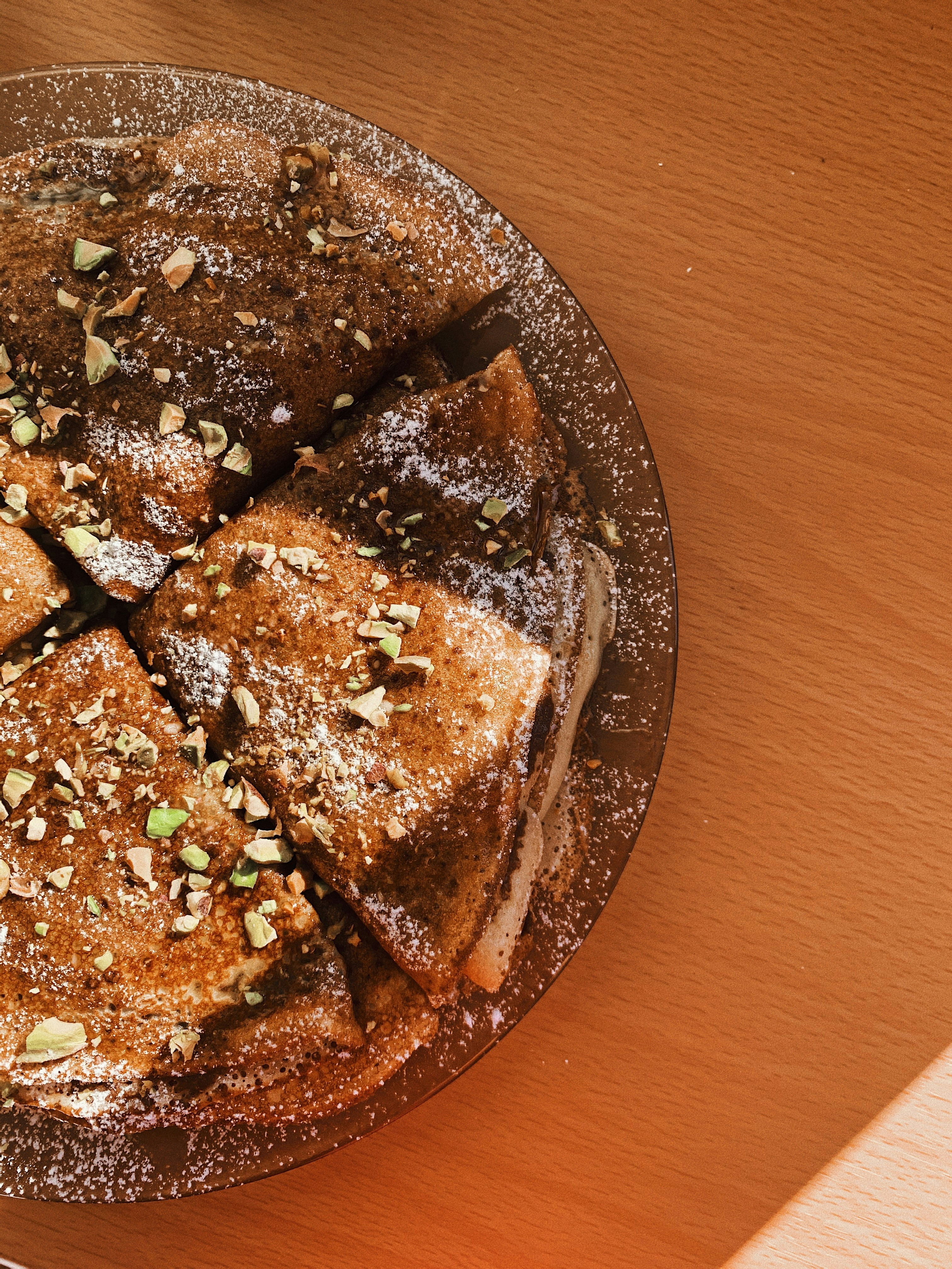 brown and green food on brown wooden round plate