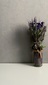 purple flowers in brown ceramic vase