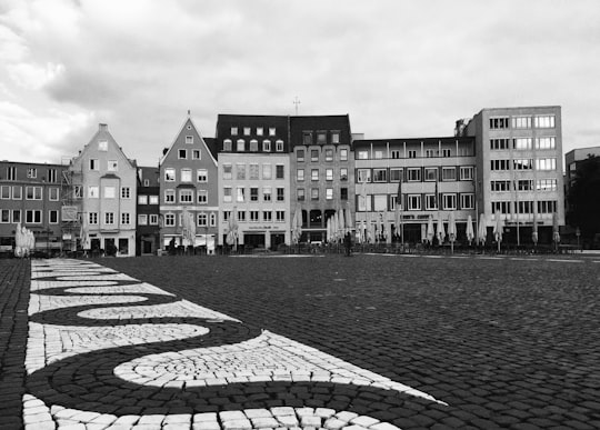 grayscale photo of buildings near body of water in Rathausplatz Germany