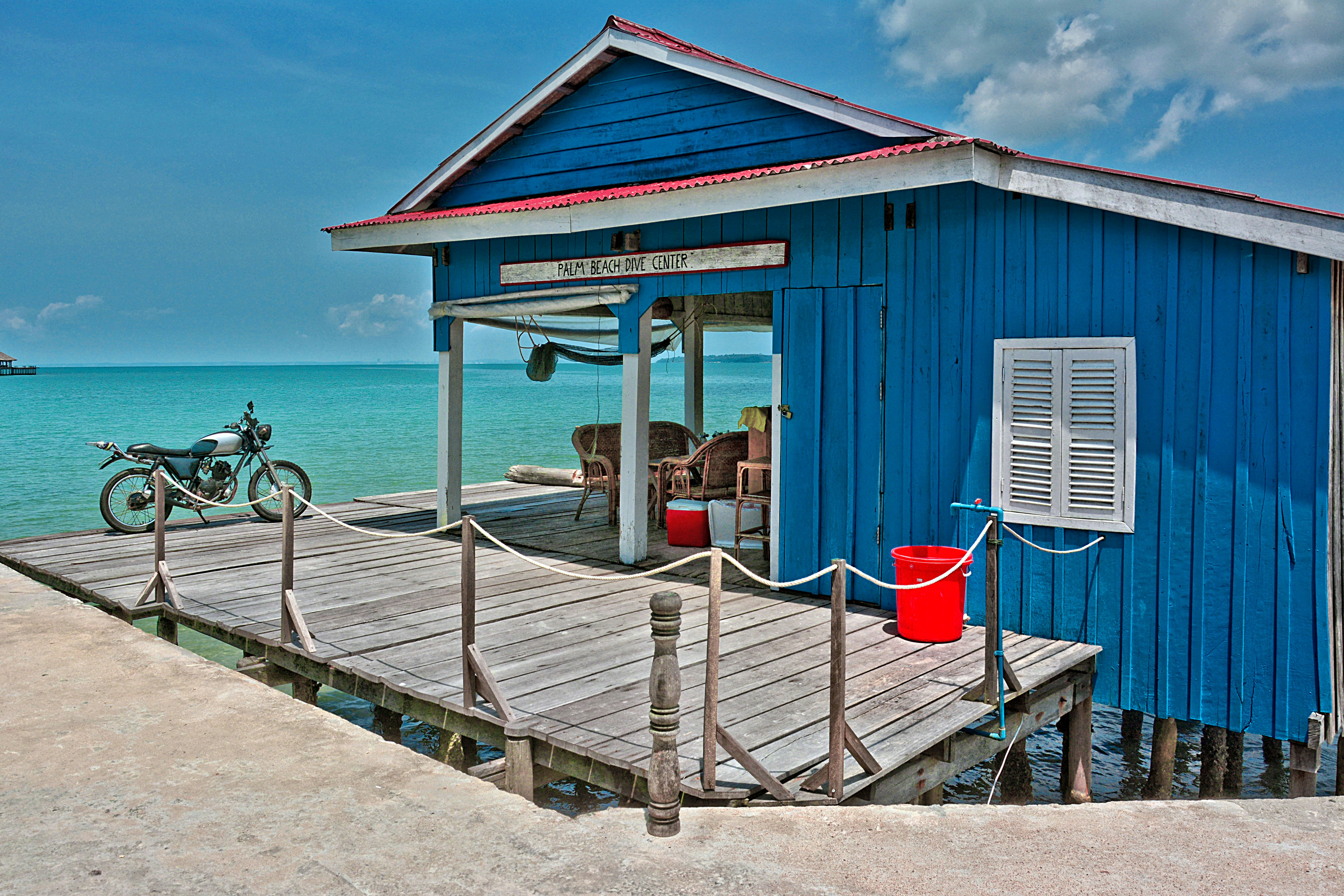 red and white wooden house near sea during daytime, Seaside motorbike ride