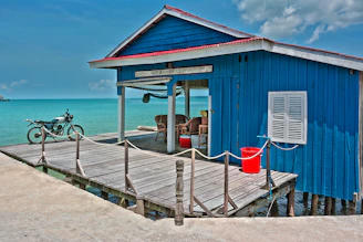 red and white wooden house near sea during daytime