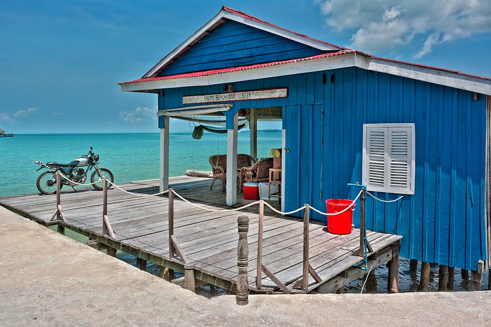 red and white wooden house near sea during daytime