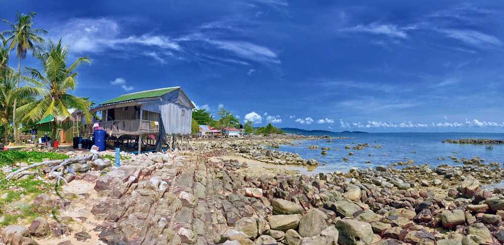 white wooden house near body of water during daytime