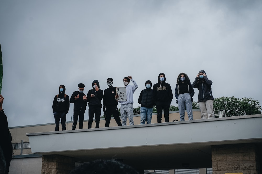 group of people standing on top of building