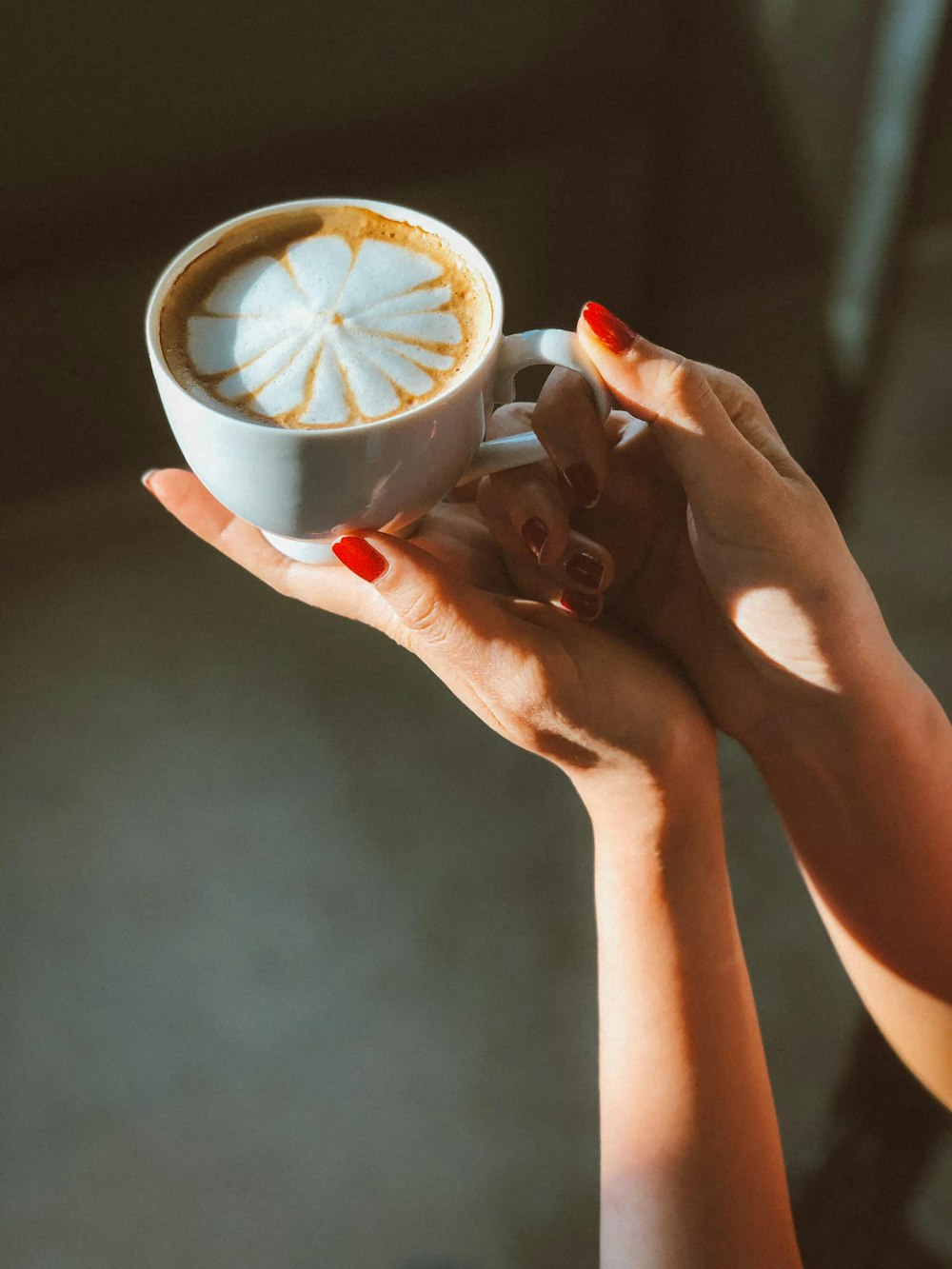 person holding white ceramic mug with lemon