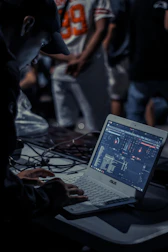 Close-up of hands organizing digital music files and contracts.