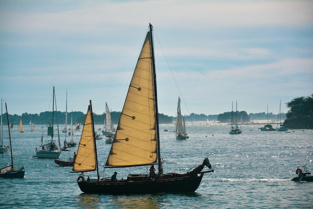 brown and white sail boat on sea during daytime