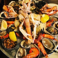 A vibrant seafood platter featuring shrimp, fish, and shellfish on a wooden table.