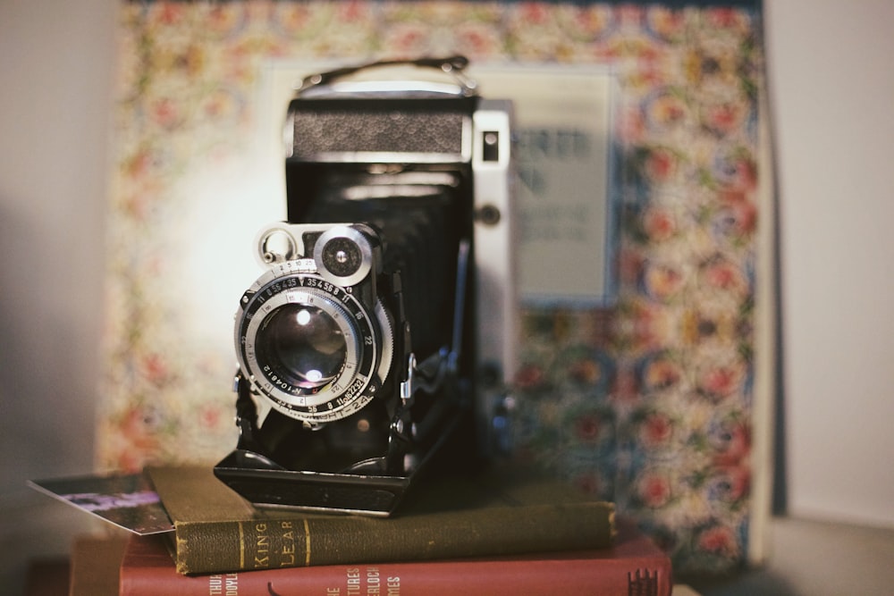 black and silver camera on brown wooden table