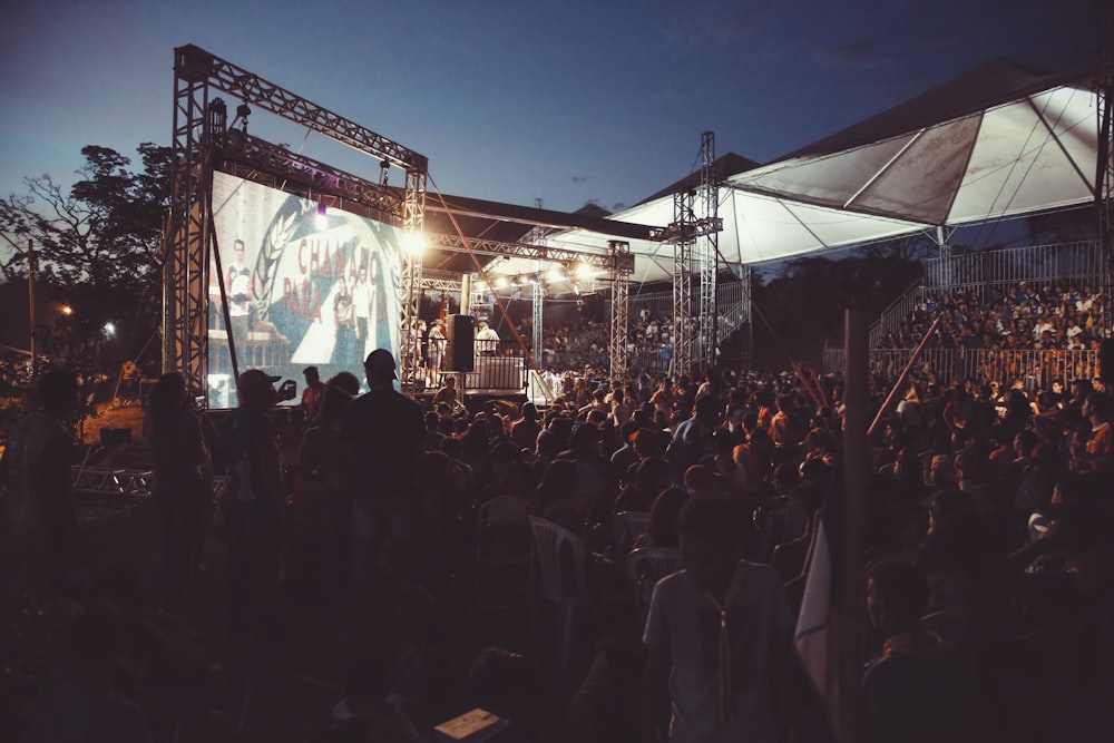 people standing on stage during night time