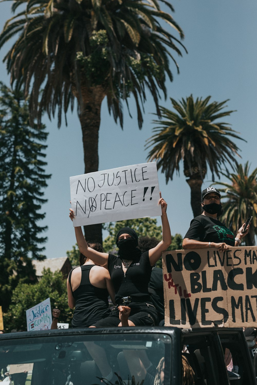 man in black t-shirt holding white and blue i love you signage