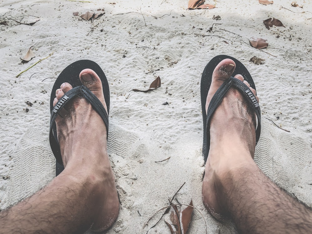 person wearing black flip flops