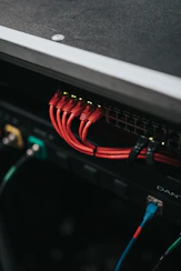 Close-up of network cables connected to a high-tech switch in a data center.