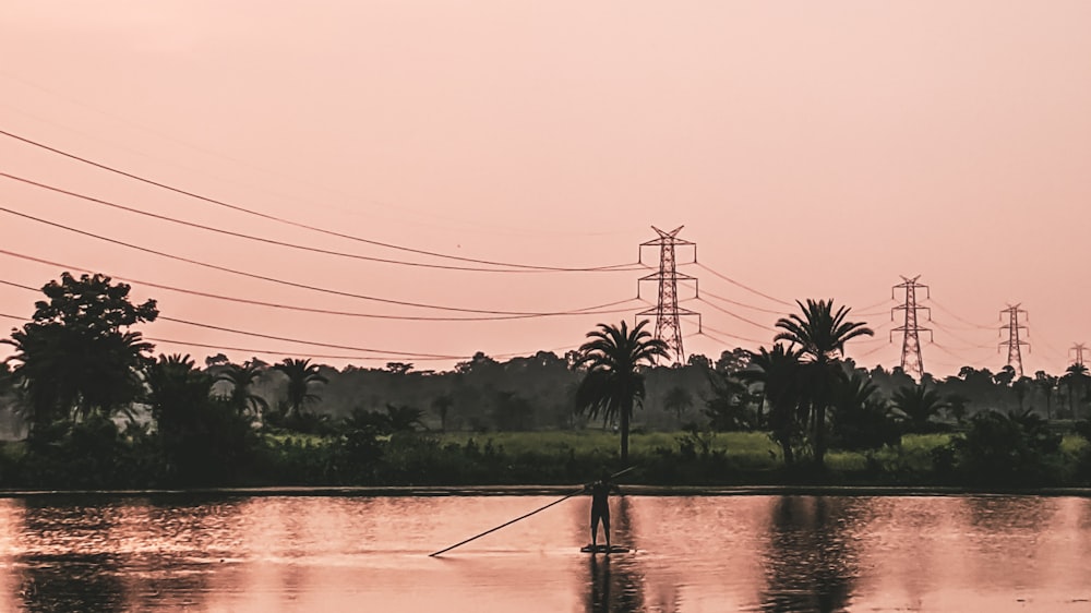 body of water near green trees during daytime