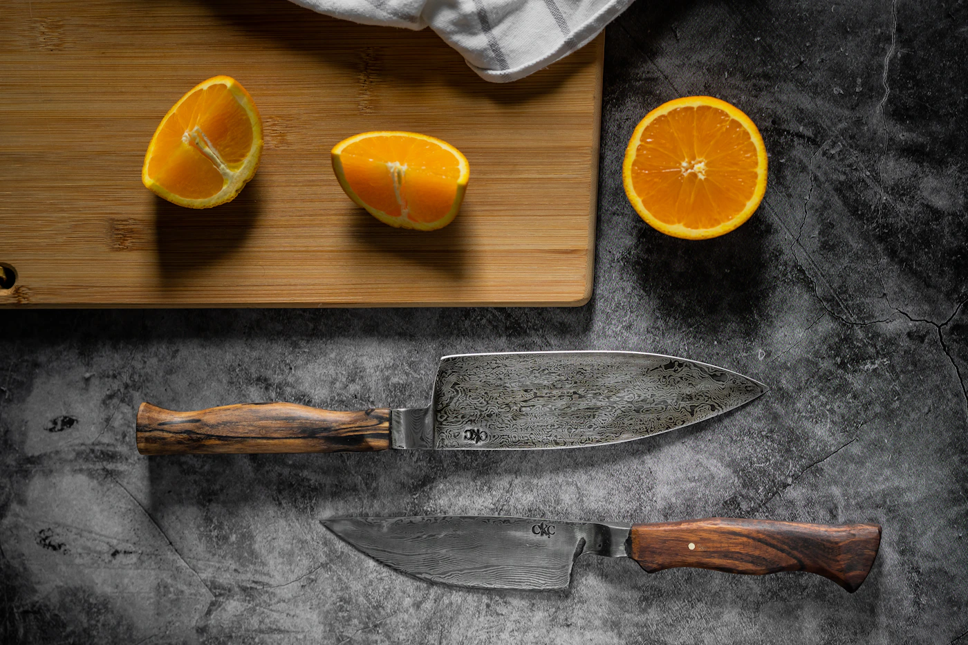 Kitchen knives beside a cutting board with fresh citrus