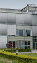 red flowers beside glass building