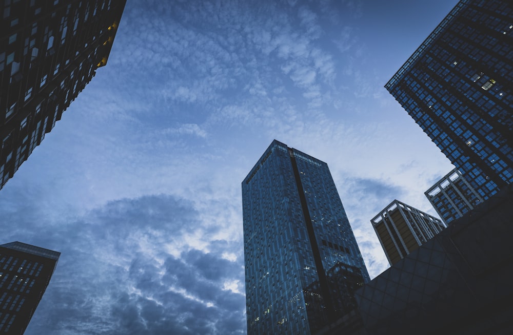 low angle photography of high rise building under blue sky