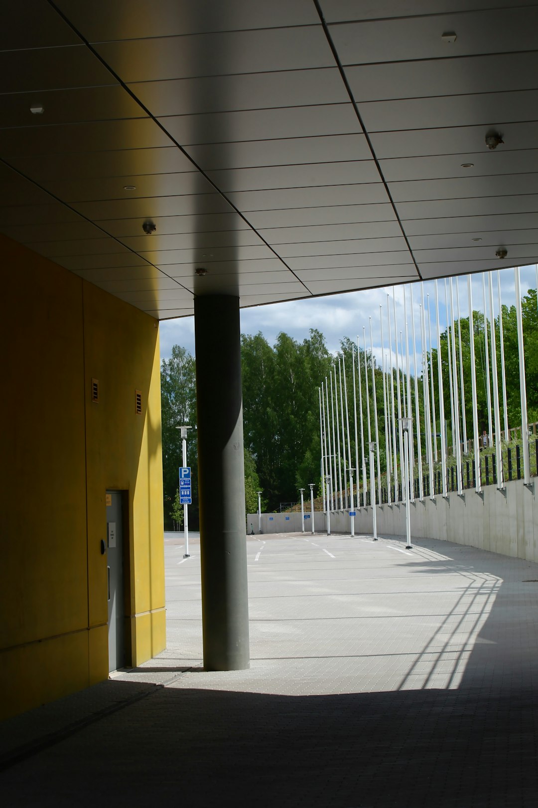 black and white metal post near yellow concrete building