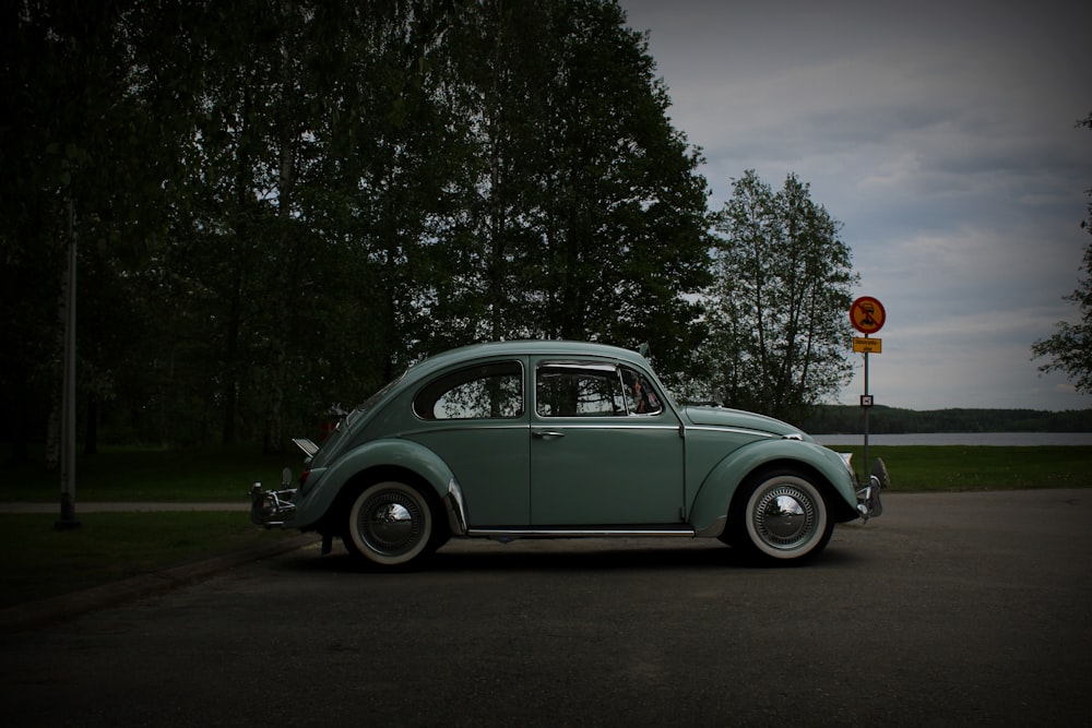 white volkswagen beetle parked on the side of the road