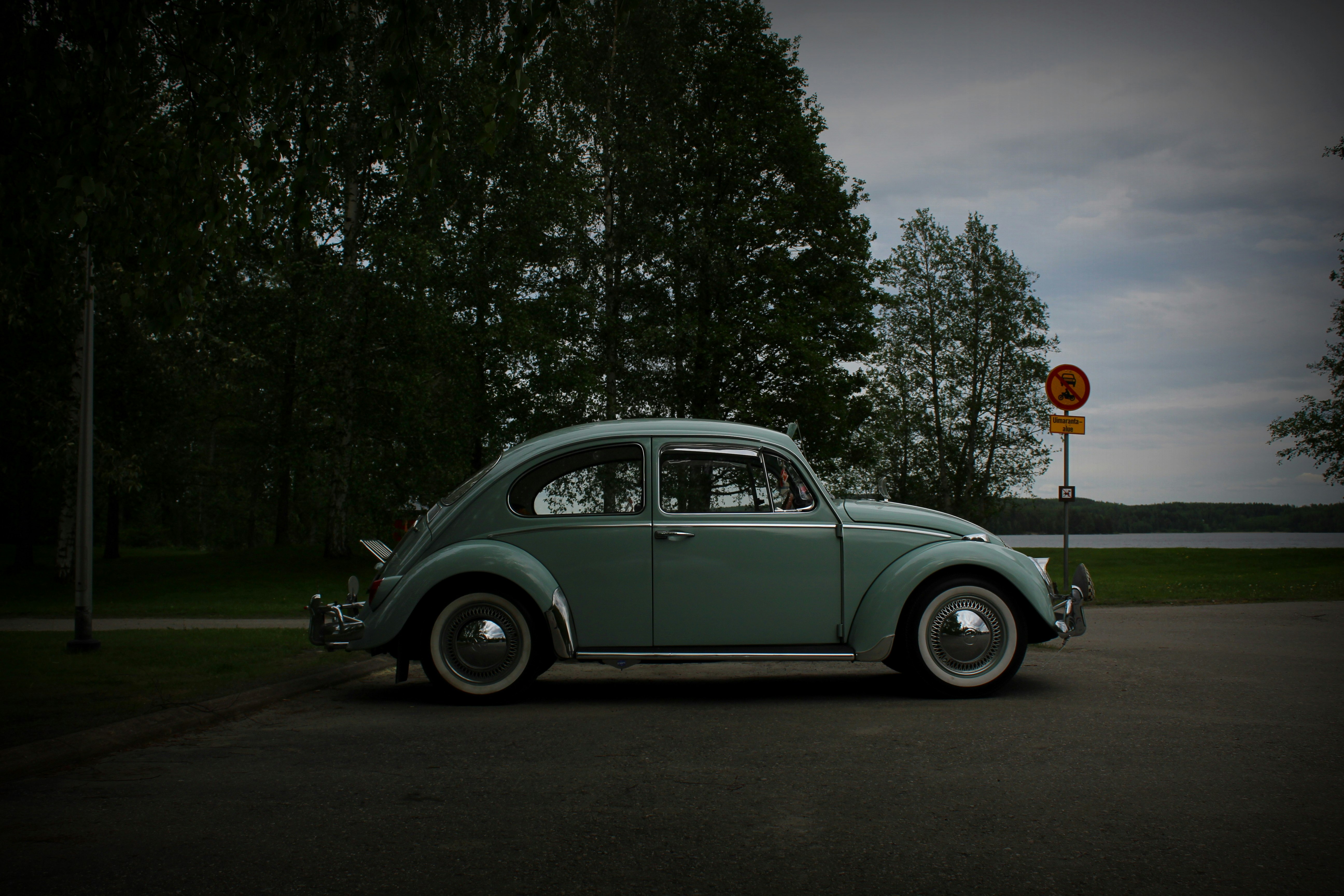 white volkswagen beetle parked on the side of the road