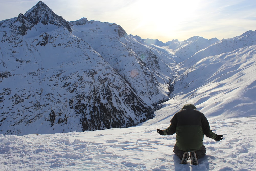 person in black jacket and black pants walking on snow covered ground during daytime