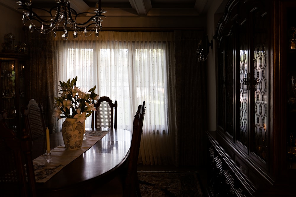 clear glass vase on brown wooden table