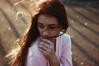 woman in pink long sleeve shirt wearing eyeglasses
