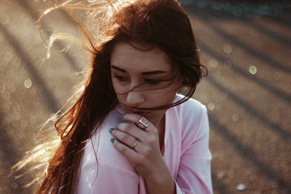 woman in pink long sleeve shirt wearing eyeglasses