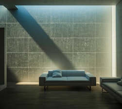 A clean sofa in a bright, minimalist living room with natural light.