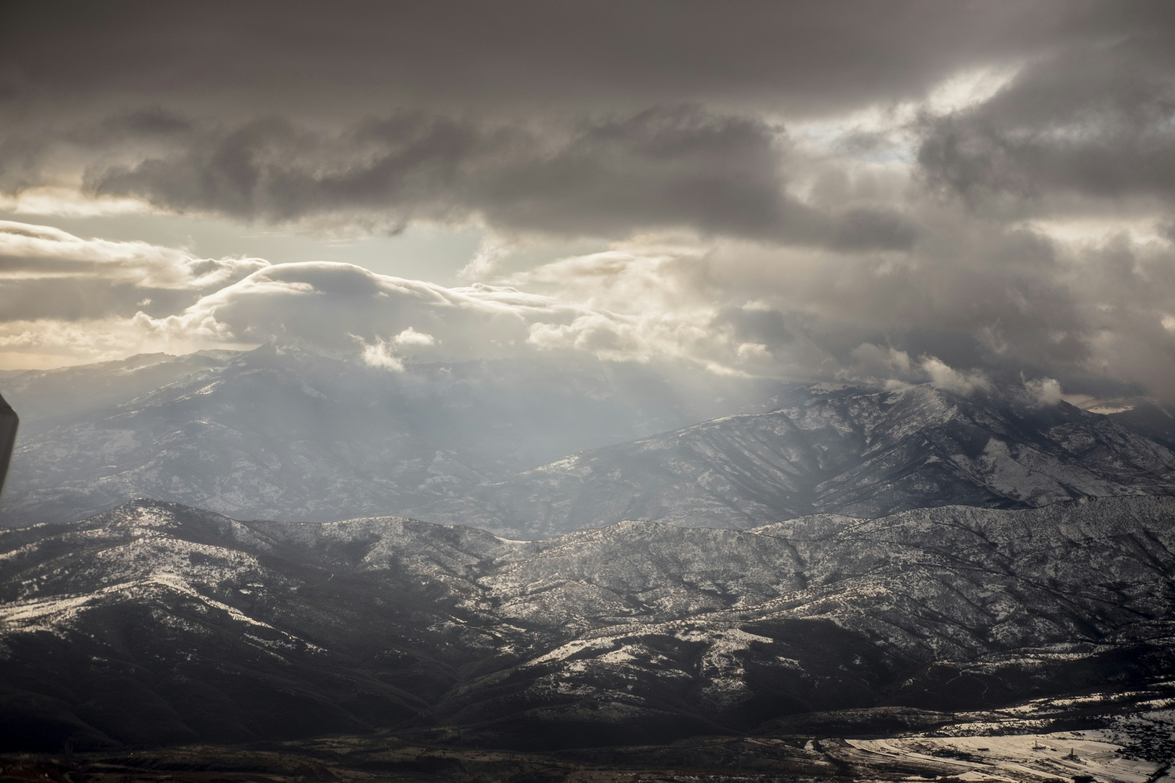 snow covered mountains under white clouds during daytime