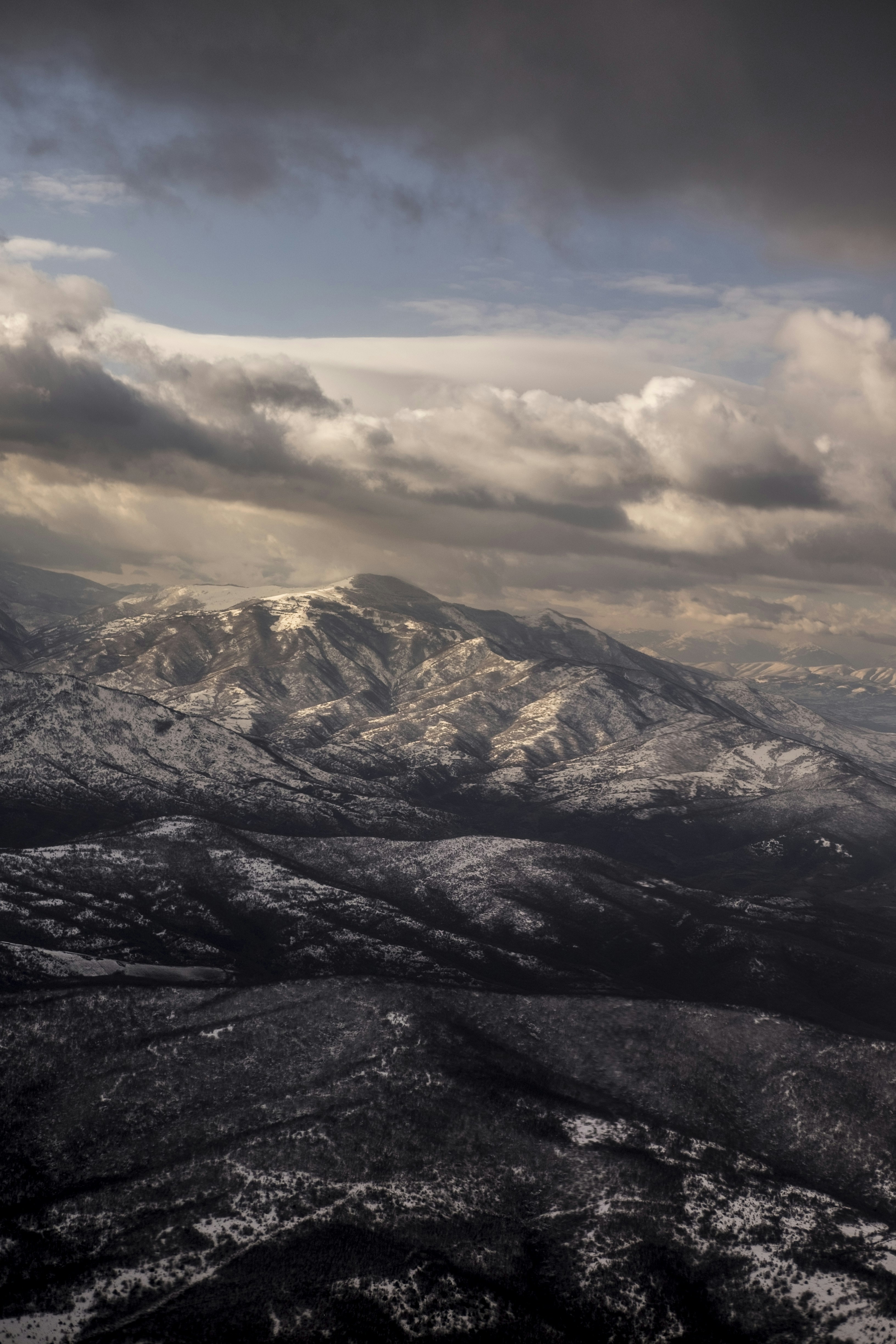black and white mountains under white clouds