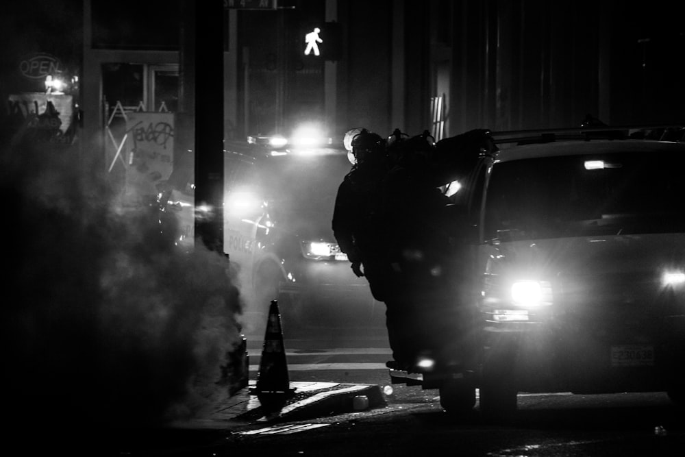 grayscale photo of cars on road