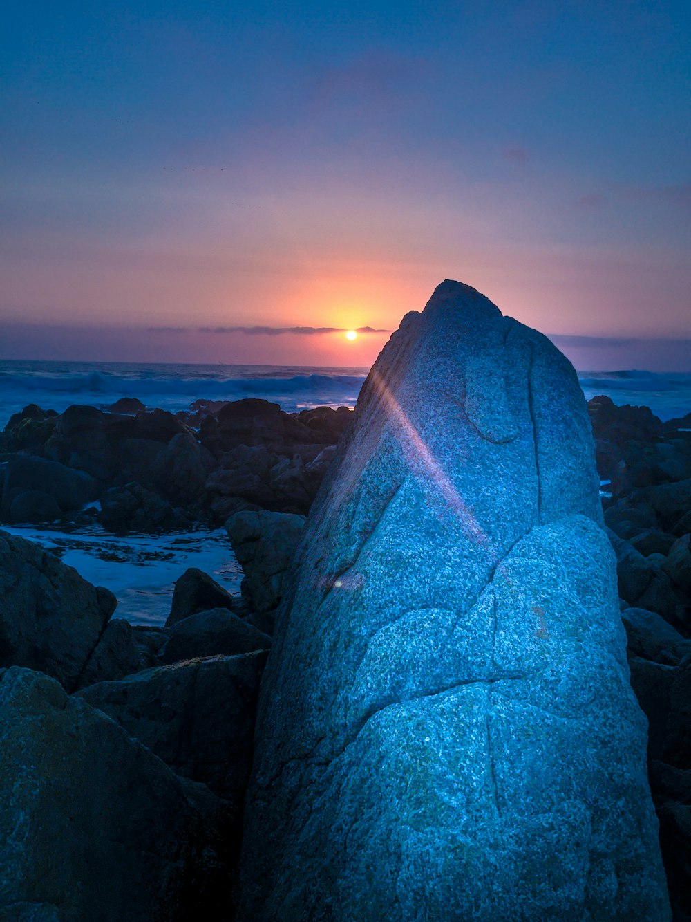 gray rock formation near body of water during daytime