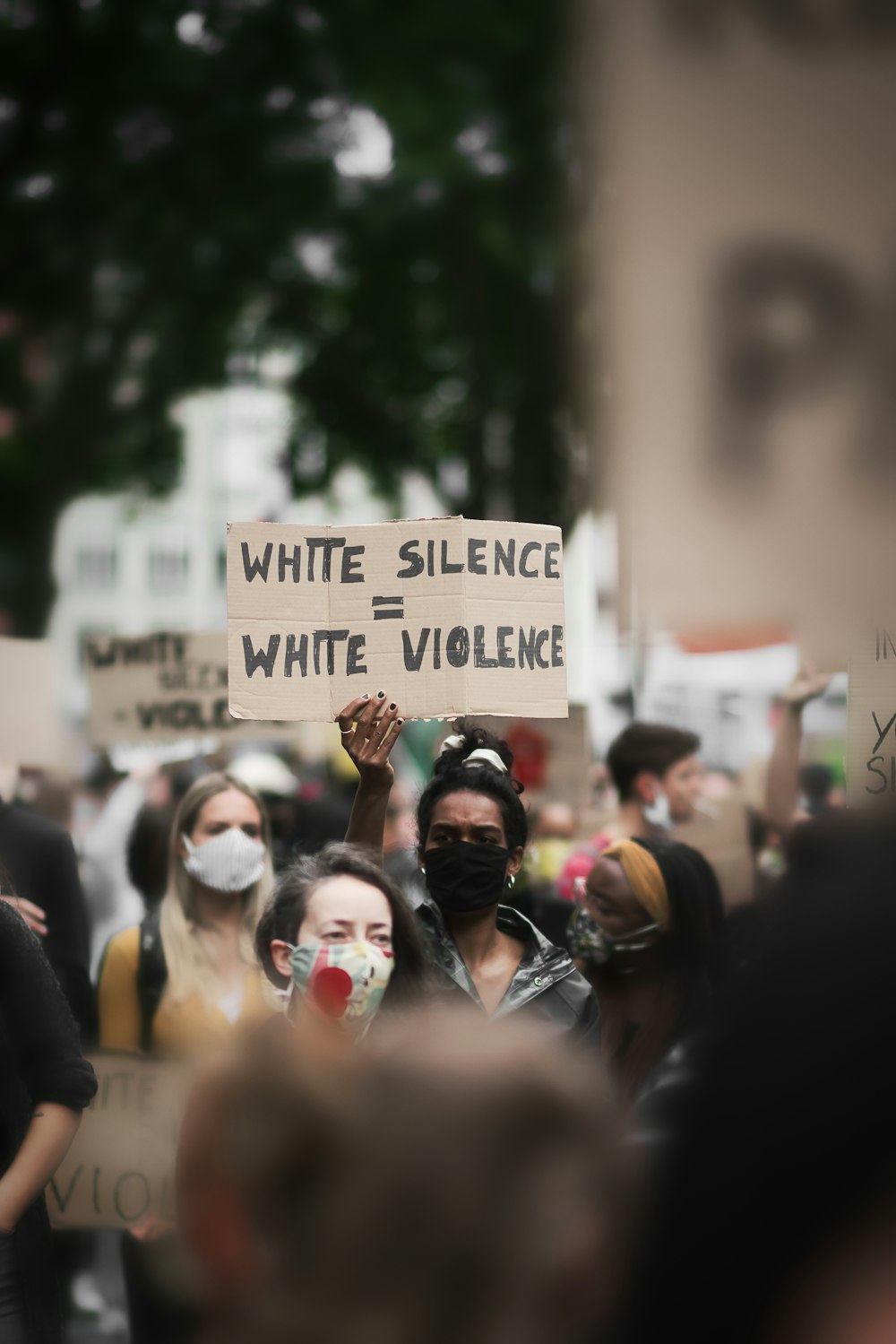 people holding white and black signage during daytime