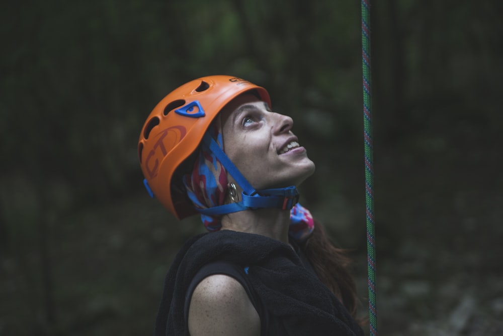 woman in black tank top wearing orange helmet