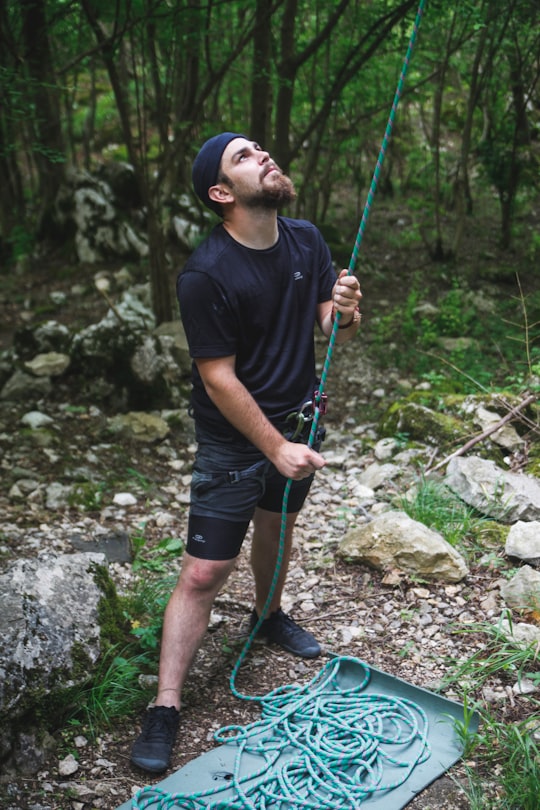 man in black crew neck t-shirt and black shorts holding green and black stick in Transylvania Romania