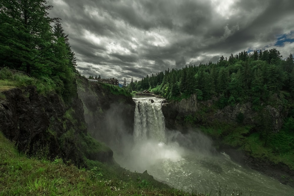 waterfalls under gray cloudy sky during daytime