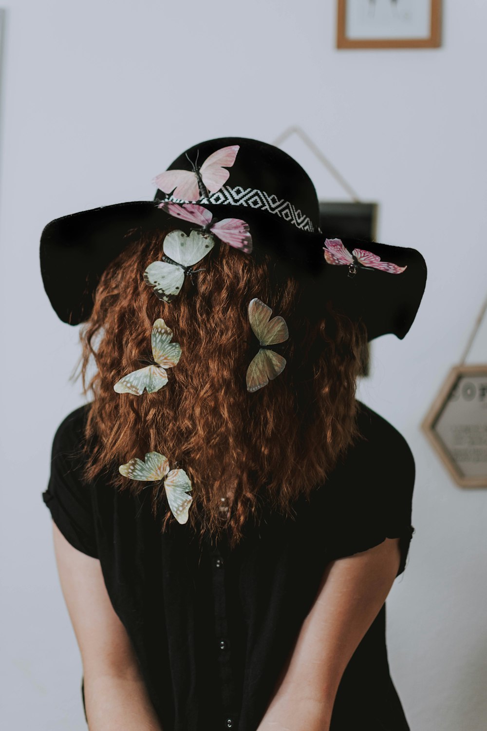 woman in black shirt wearing black hat